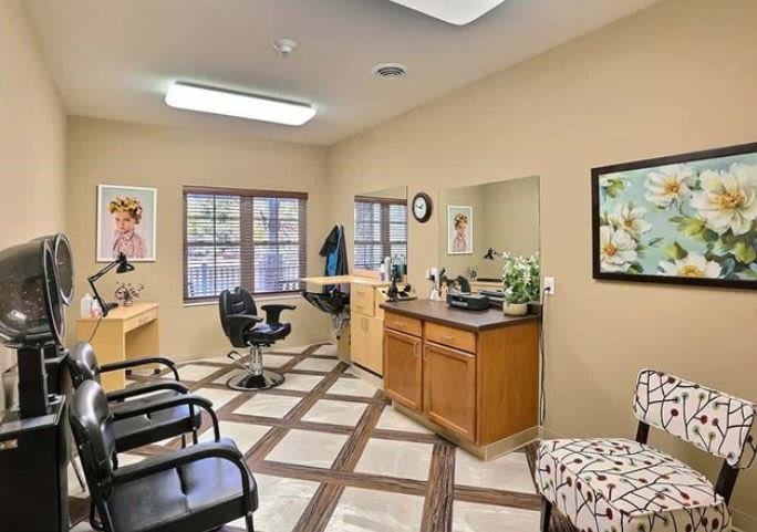 A cozy hair salon with stylish chairs, large mirrors, and bright windows.