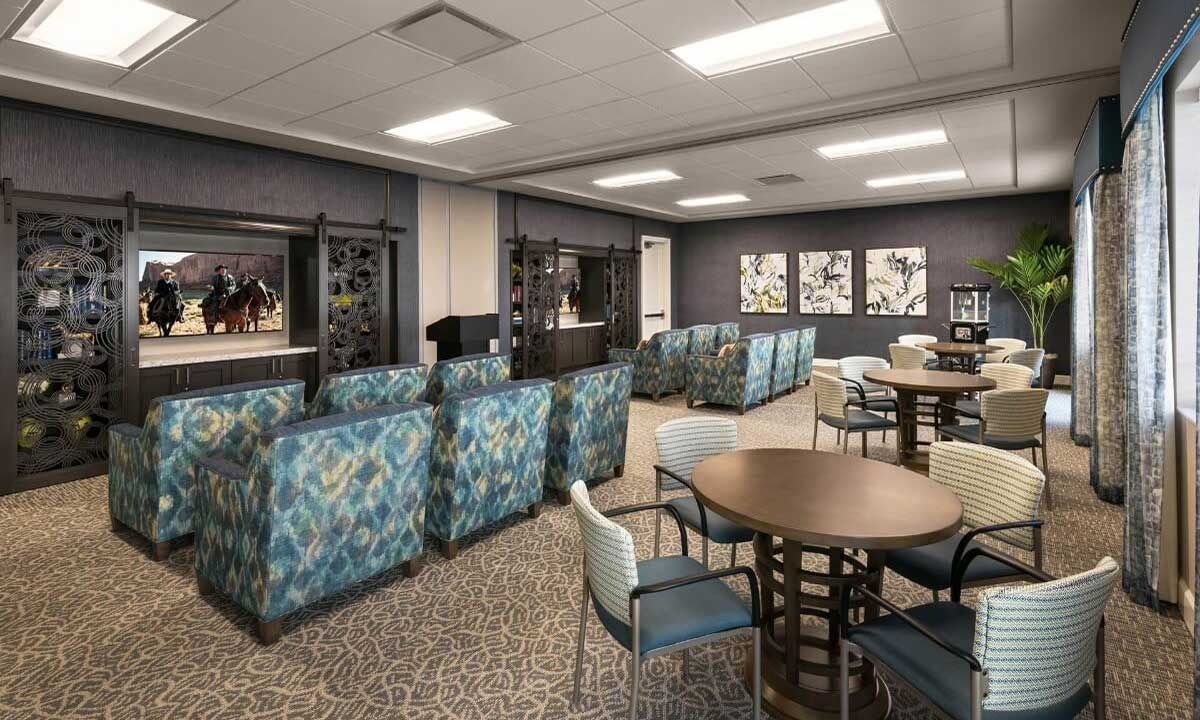 A modern lounge area with comfortable seating and round tables, featuring a stylish interior design.