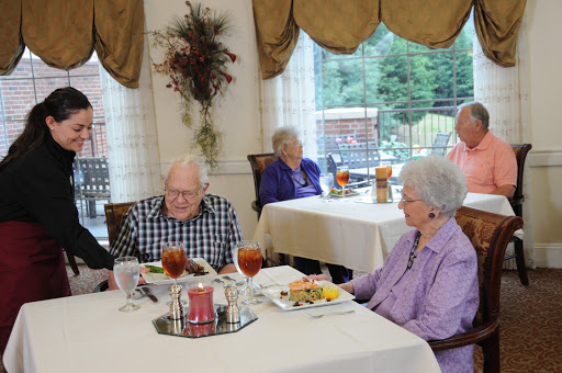 A group of seniors enjoying a meal together in a cozy dining area.