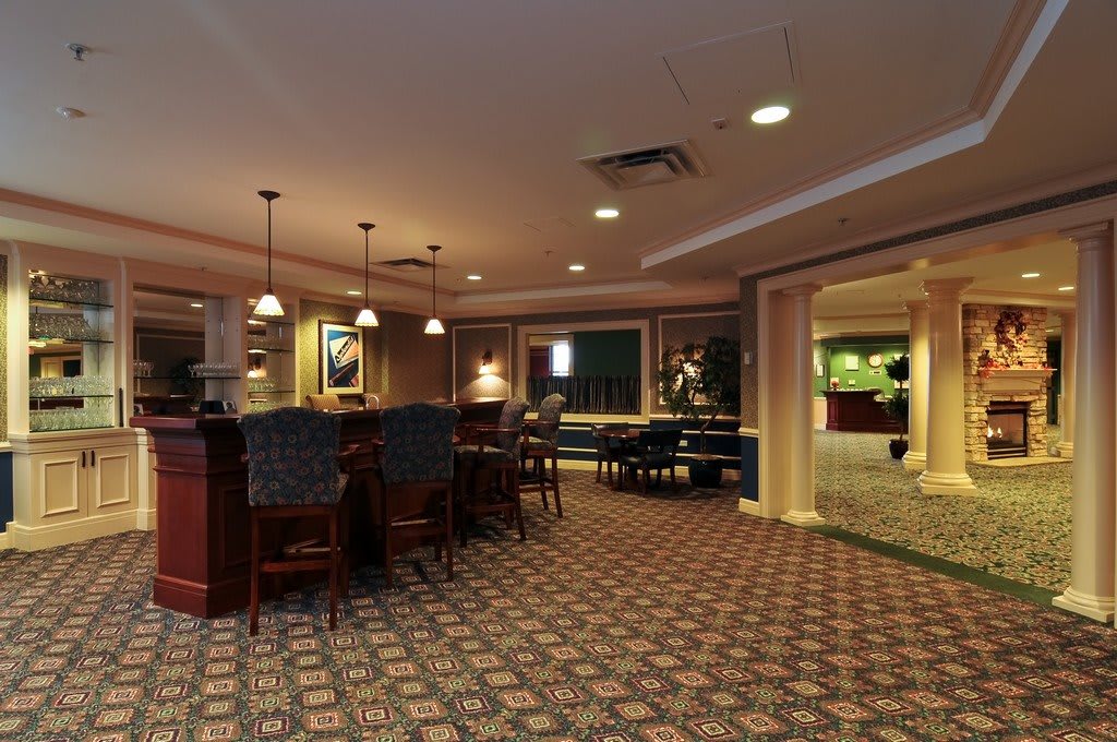 A cozy lounge area with bar seating and warm lighting.
