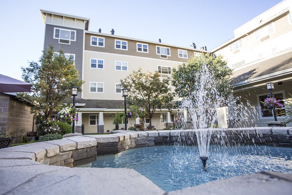 A residential building with a central courtyard featuring a decorative fountain.