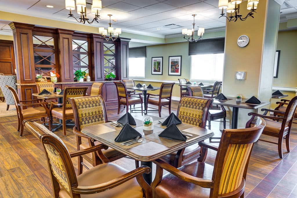 A well-decorated dining area with elegant furniture and chandeliers.