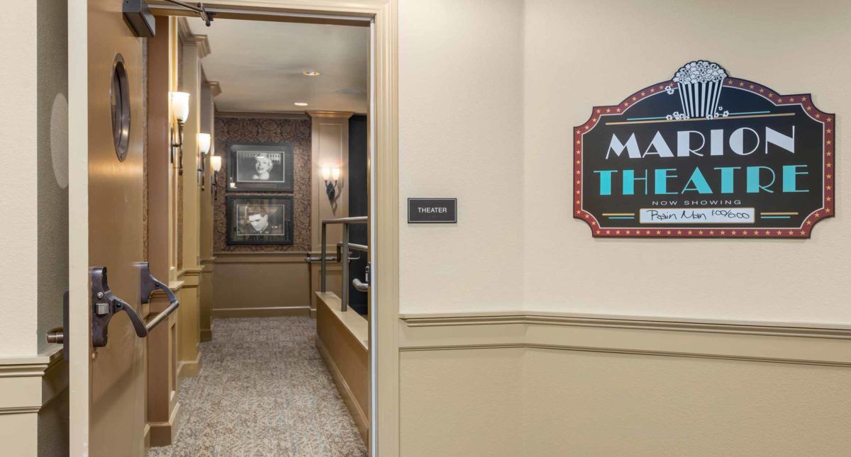 A hallway with a 'Main Theater' sign next to a doorway leading inside.