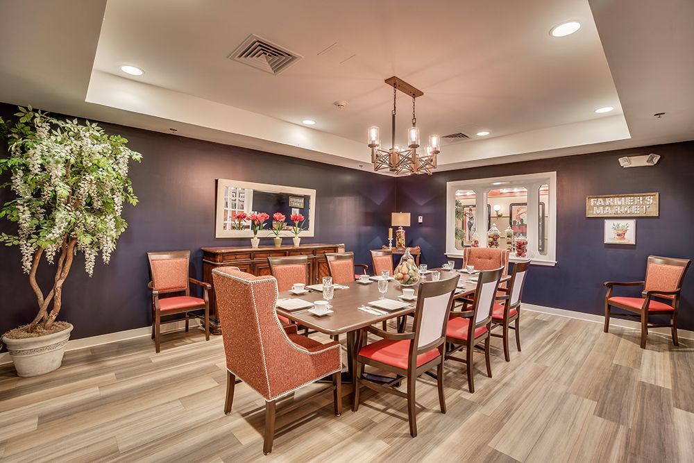 A beautifully decorated dining room with a large table, comfortable chairs, and a chandelier.