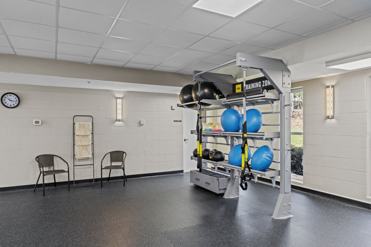A well-equipped gym with various fitness tools, including medicine balls and exercise mats.