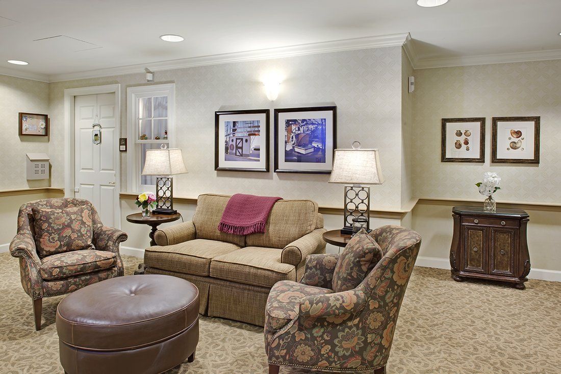 A cozy living room featuring a sofa, two armchairs, and stylish decor.