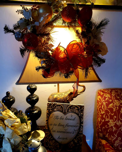 A beautifully decorated lamp adorned with a festive wreath, adding warmth and charm to the room.
