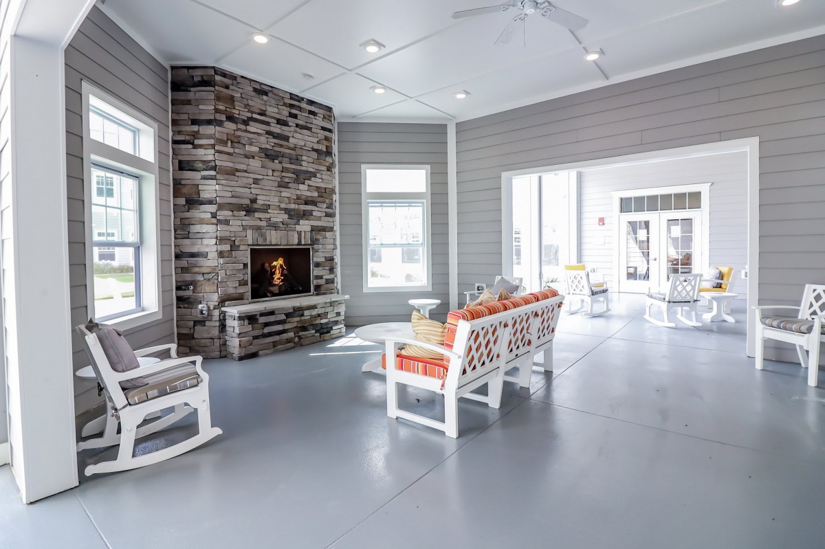 A modern living room with a cozy fireplace and stylish furniture.