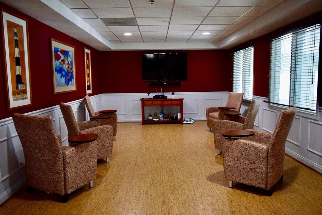 A modern lounge area with comfortable seating and a television.
