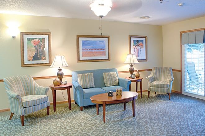 A cozy living room with comfortable seating and decorative artwork.