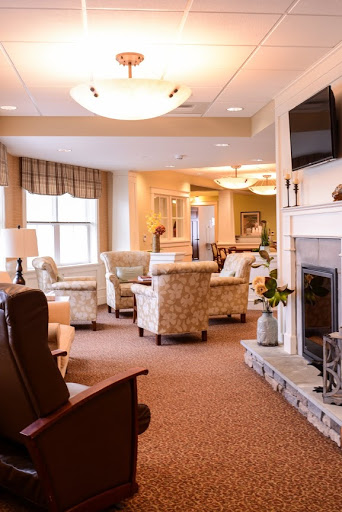 A cozy and inviting lounge area featuring comfortable seating and a warm fireplace.