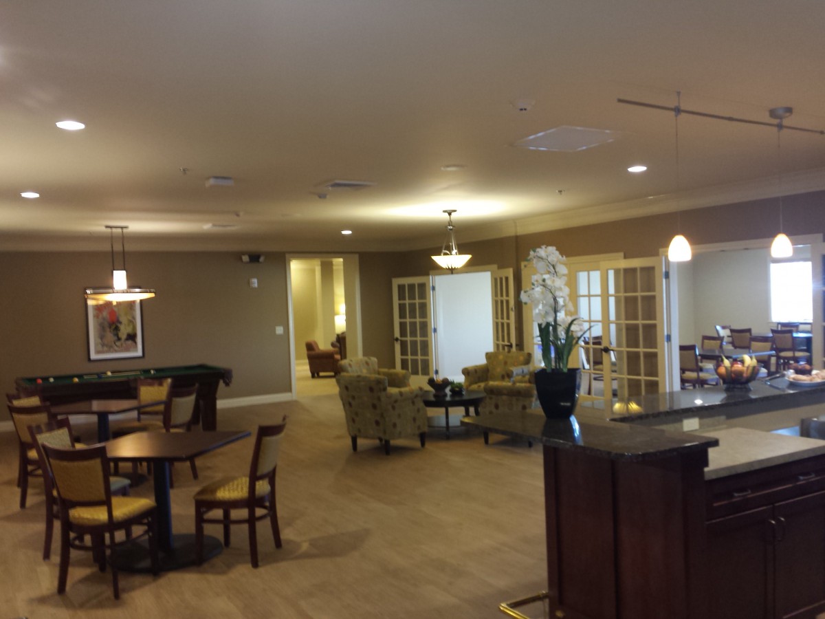 A spacious living area with seating and warm lighting.