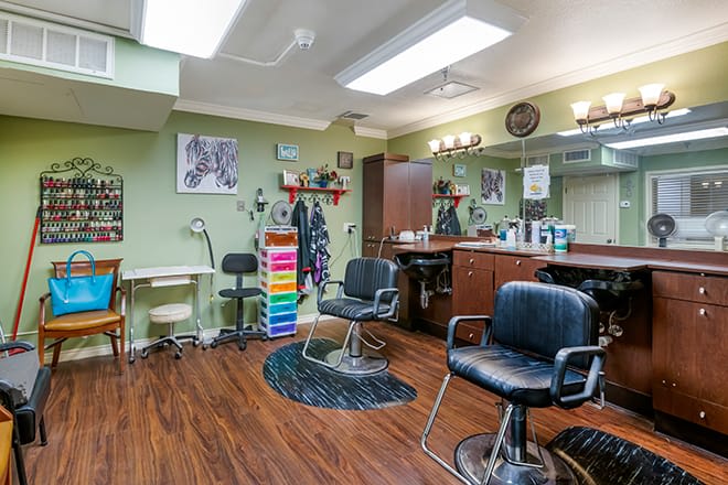 A well-equipped hair salon with chairs, mirrors, and various hairdressing tools arranged neatly.