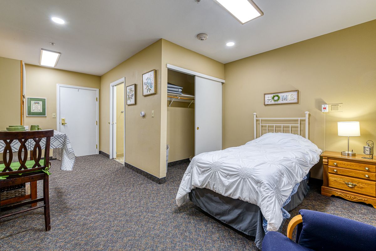 A cozy bedroom with a single bed and simple decor.