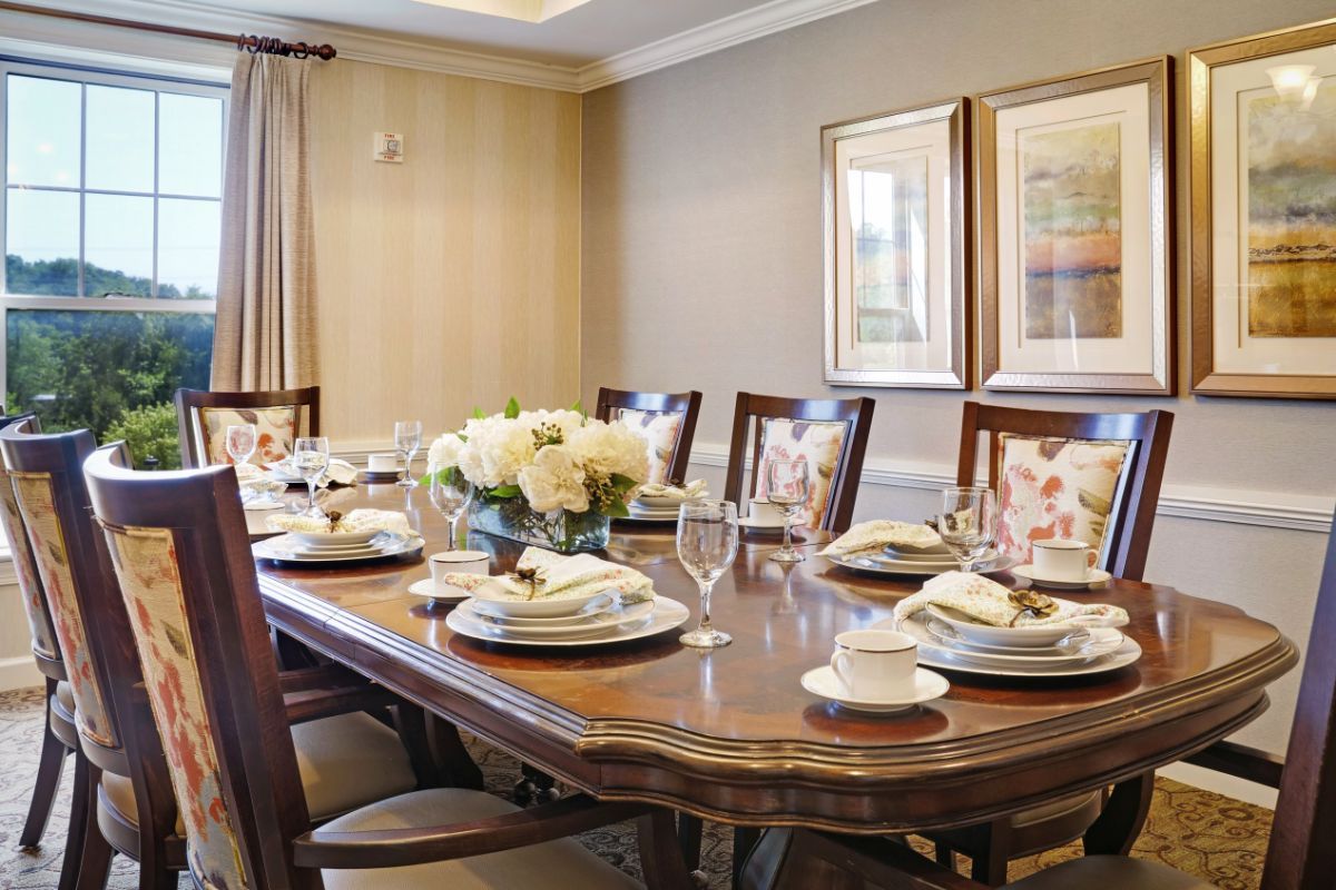 A beautifully set dining table adorned with floral centerpieces in an elegant dining room.