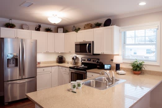 A modern kitchen featuring stainless steel appliances and a spacious countertop island.