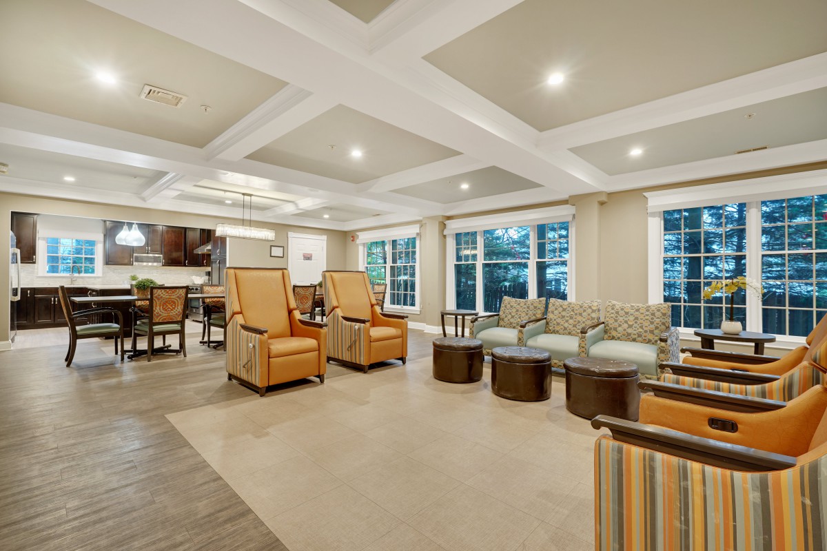 A spacious and modern living room with comfortable seating and elegant lighting.