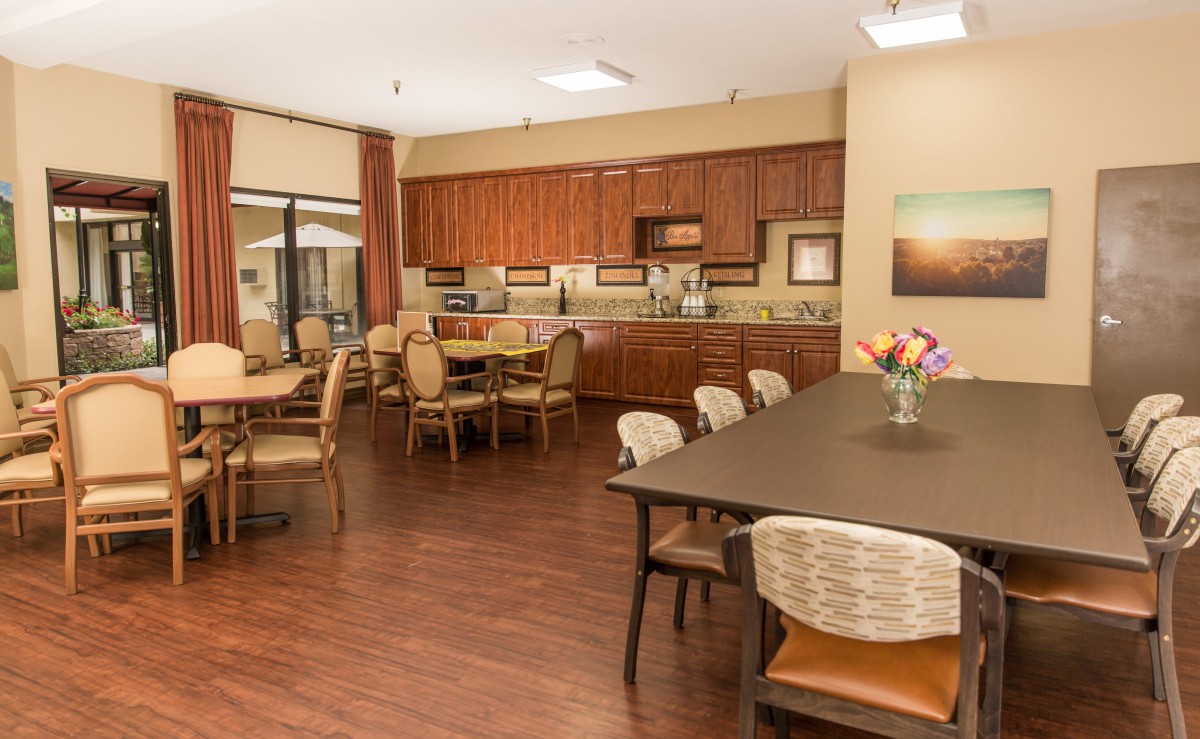 A spacious kitchen and dining area with wooden cabinets and tables.