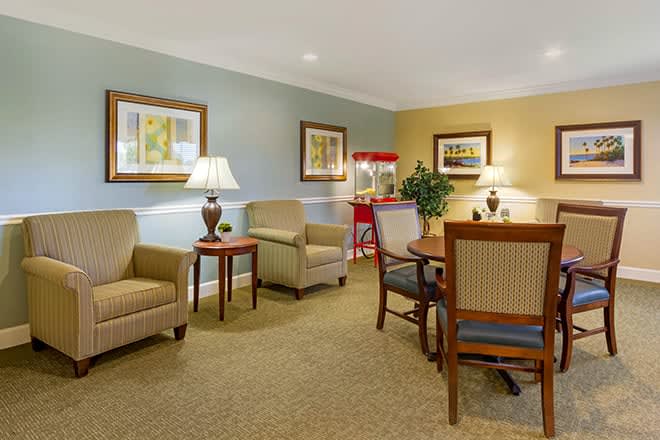 A cozy living room with comfortable seating and a popcorn machine.