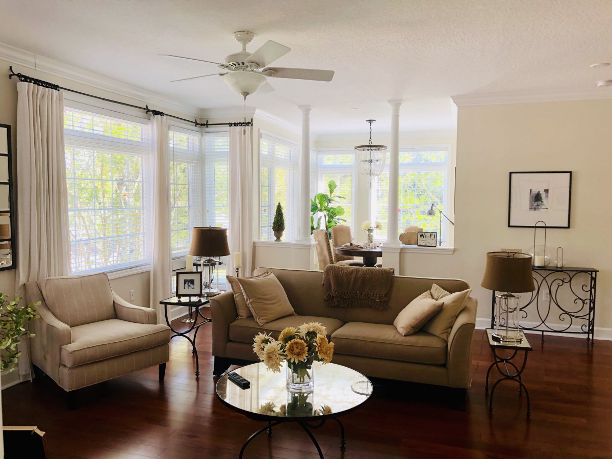A cozy and well-lit living room with comfortable seating and elegant decor.
