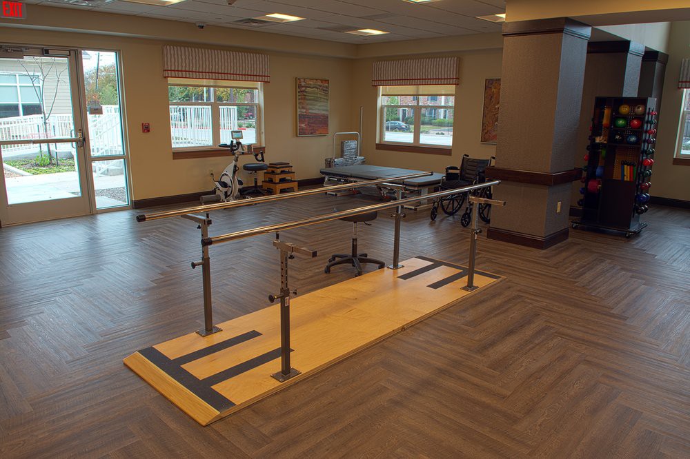 A physical therapy room equipped with parallel bars for rehabilitation exercises.