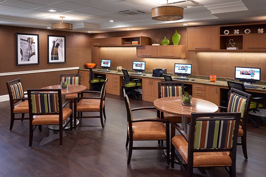 A modern office workspace featuring multiple computer stations and stylish seating arrangements.