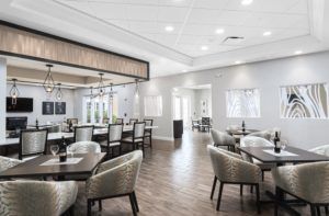 A modern restaurant dining area with tables and chairs arranged neatly.