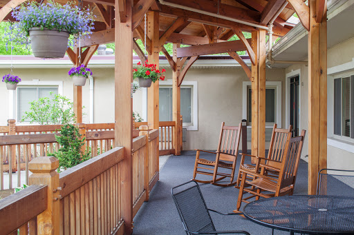 A cozy porch featuring rocking chairs and a wooden frame, perfect for enjoying the outdoors.