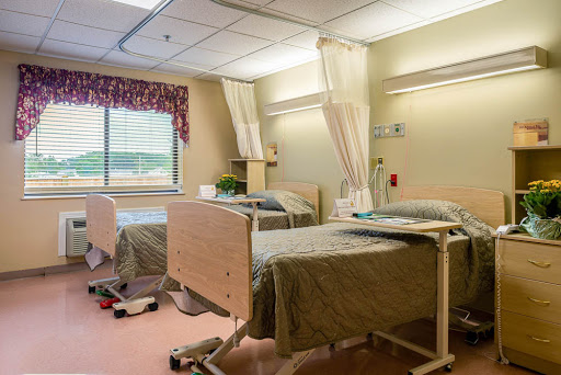 A hospital patient room with two beds, equipped for healthcare needs.