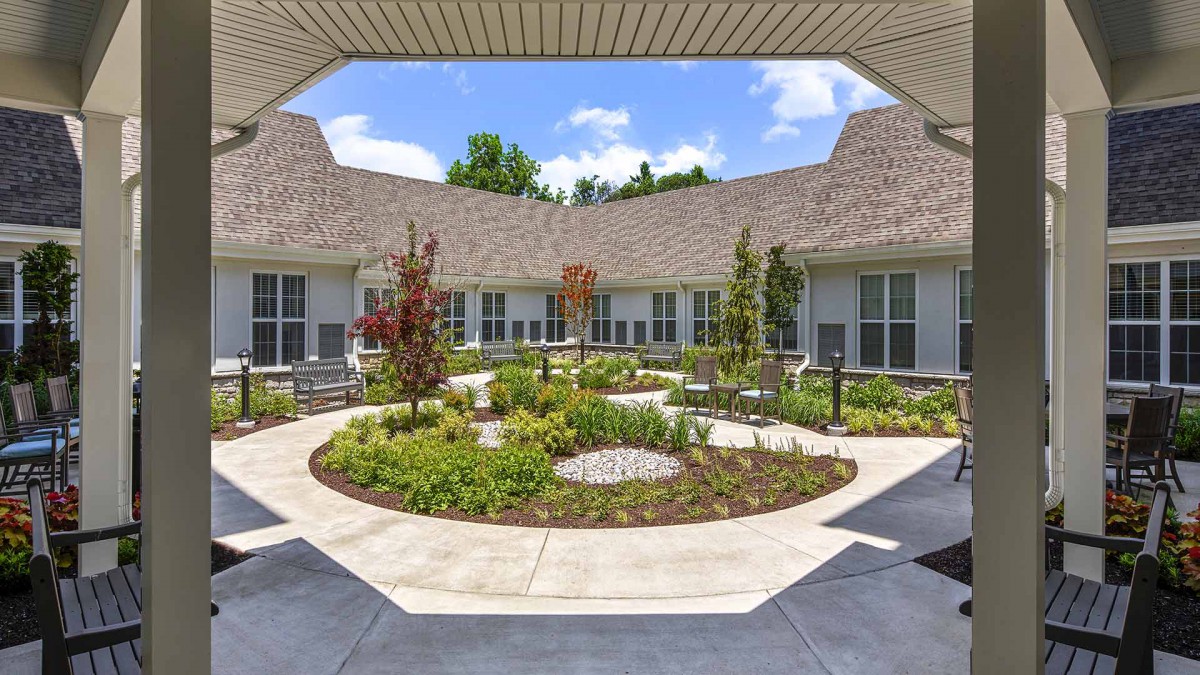 A beautifully landscaped courtyard surrounded by a building with modern architecture.