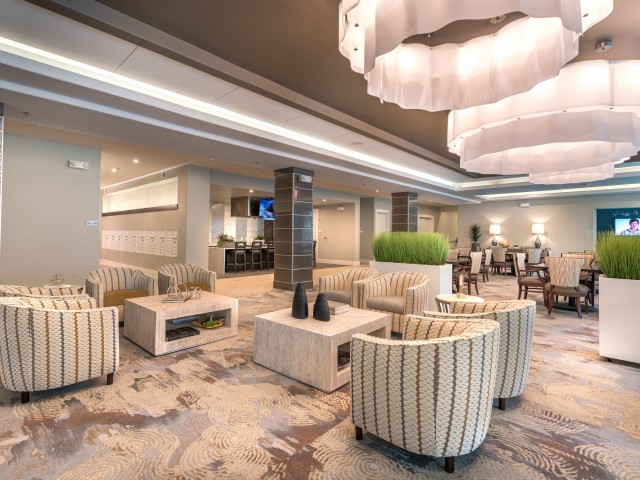 A modern and elegantly designed hotel lobby with comfortable seating and unique lighting fixtures.