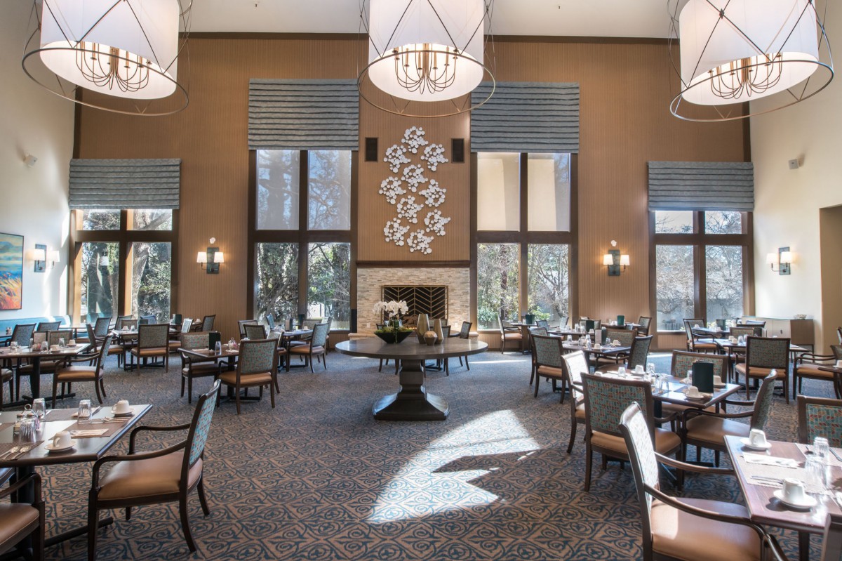 An elegant dining room with modern decor and ample natural light.
