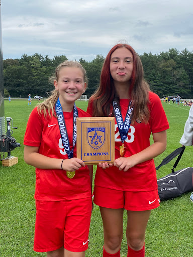 Celebrating victory at the soccer championship with medals and a proud plaque!