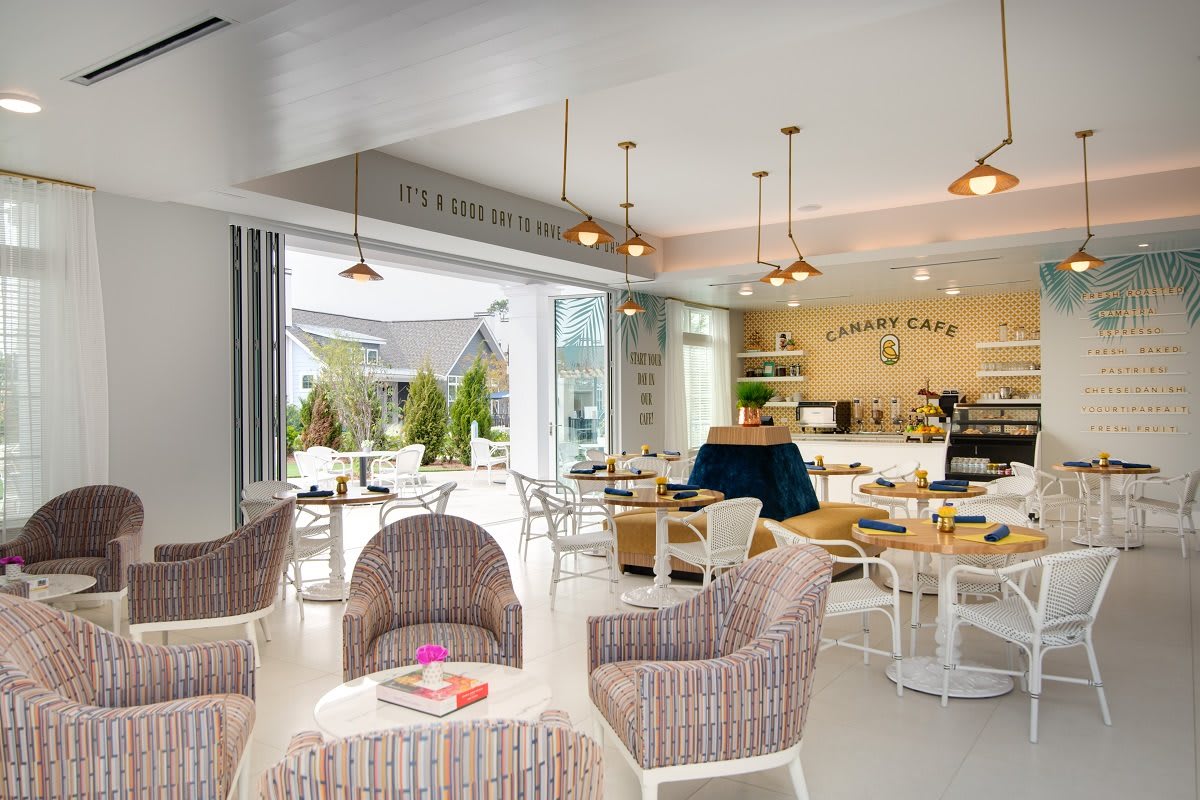 A modern, brightly lit cafe interior with comfortable seating and an inviting atmosphere.