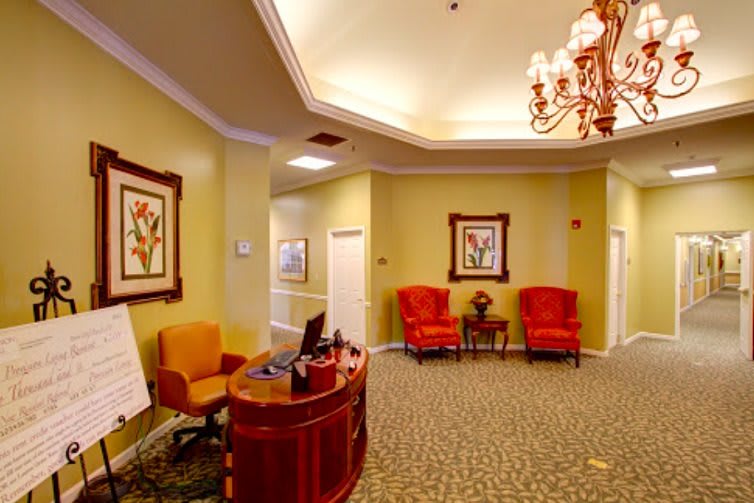 A warmly decorated lobby or reception area with comfortable seating and elegant lighting.