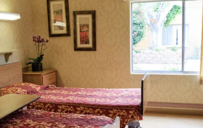 A serene spa massage room with two beds, adorned with elegant decor and soft lighting.