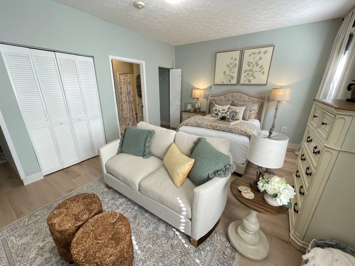 A cozy bedroom featuring a stylish sofa and elegant decor.