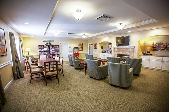 A cozy living room with comfortable seating, a dining table, and a fireplace, creating a welcoming atmosphere.