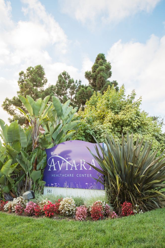 Entrance sign for Aviara Resort surrounded by lush greenery.