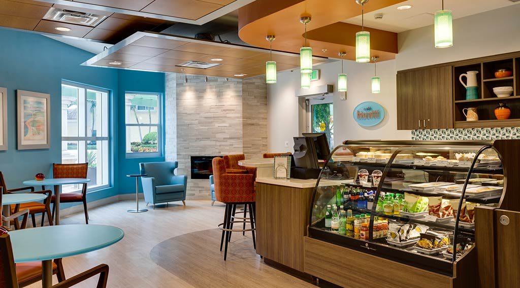 A modern cafe with a snack display and comfortable seating area.