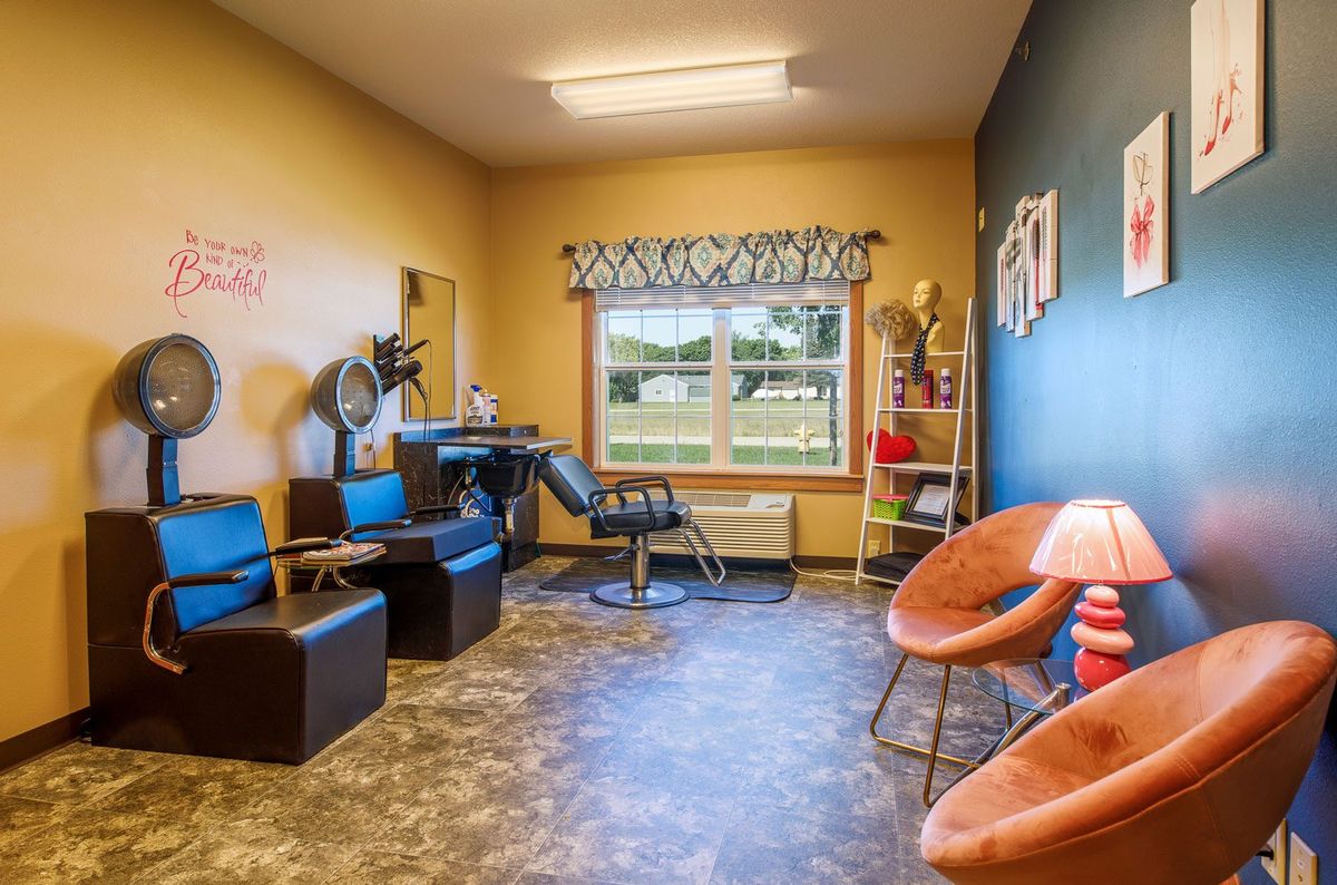 A cozy waiting room with various seating options and a large window.