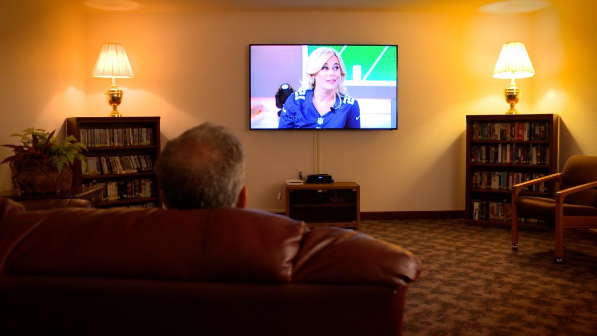 A person watching a show on television in a cozy living room.