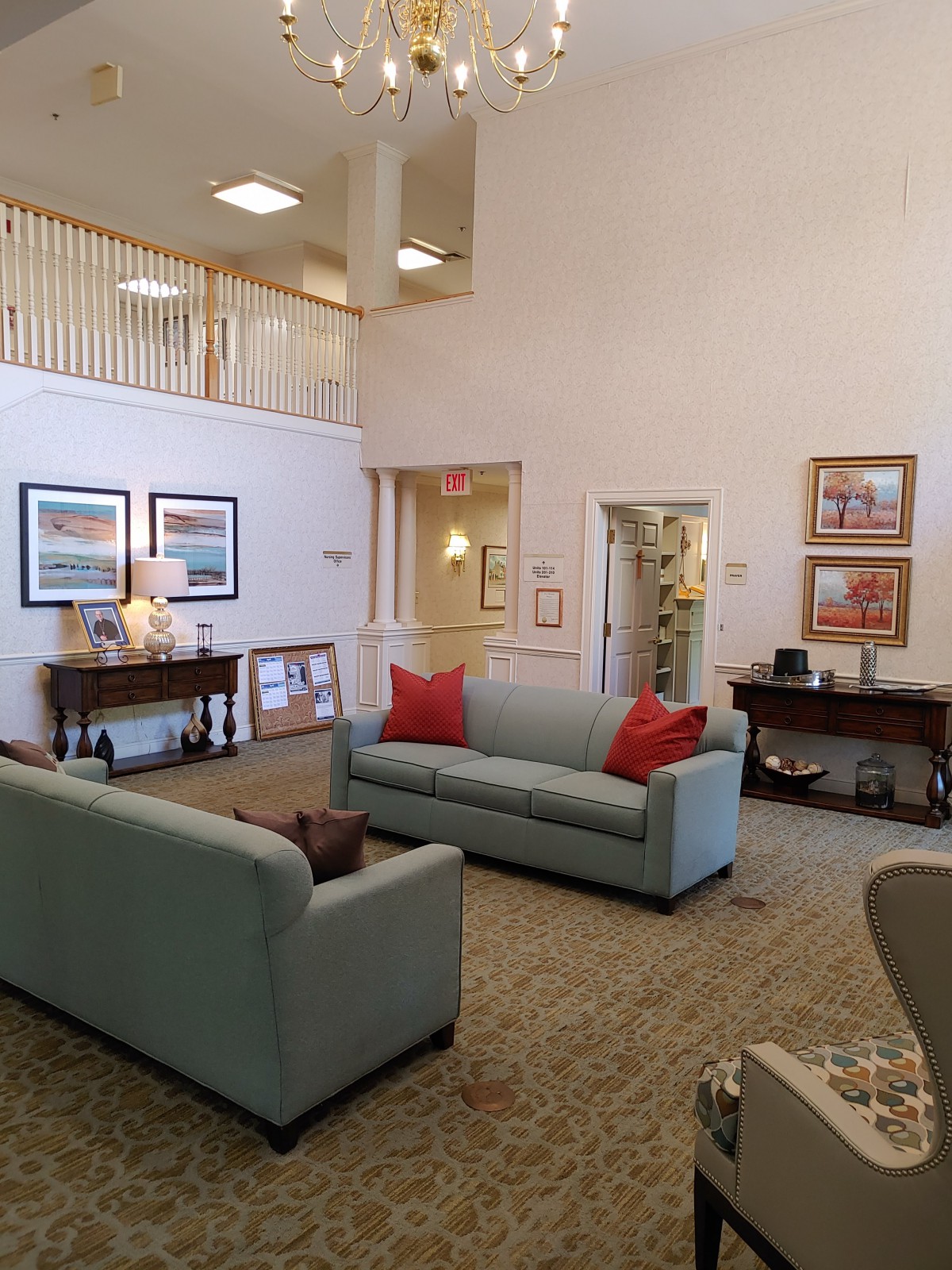 A well-decorated lobby area featuring comfortable couches and artwork on the walls.