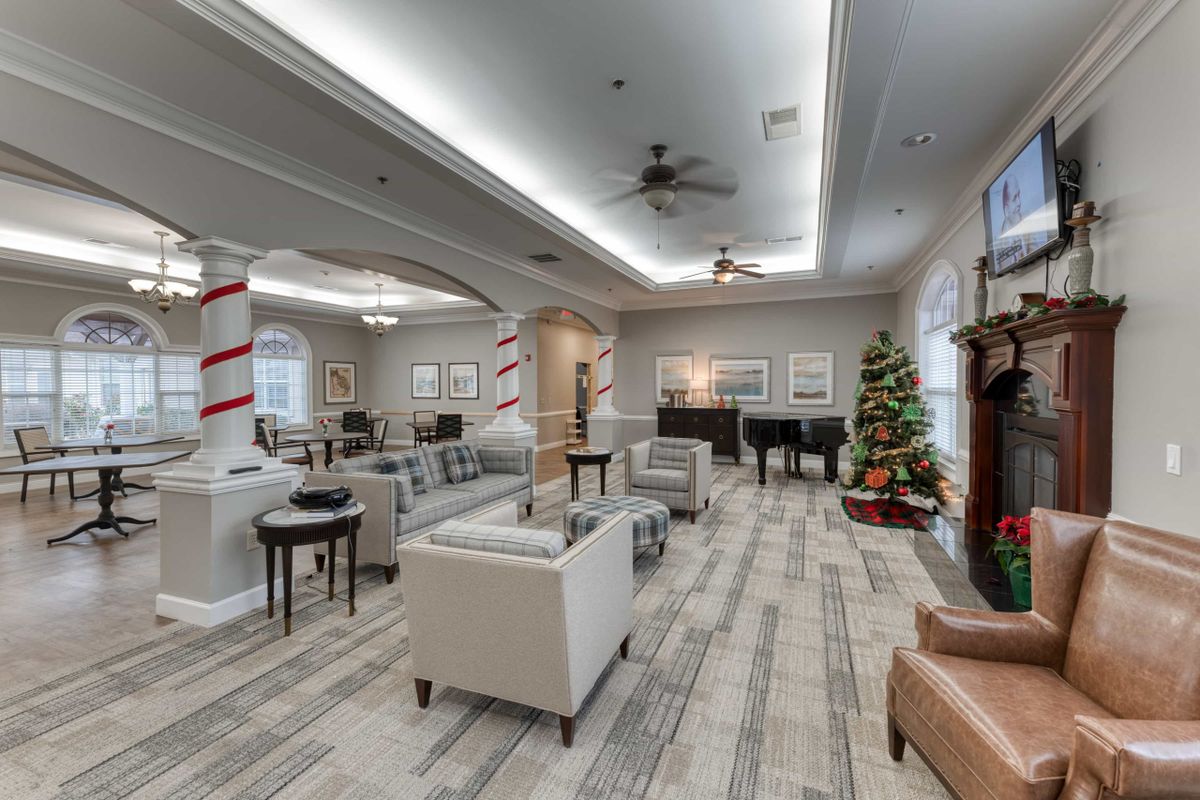 A modern living room with comfortable seating and festive Christmas decorations.