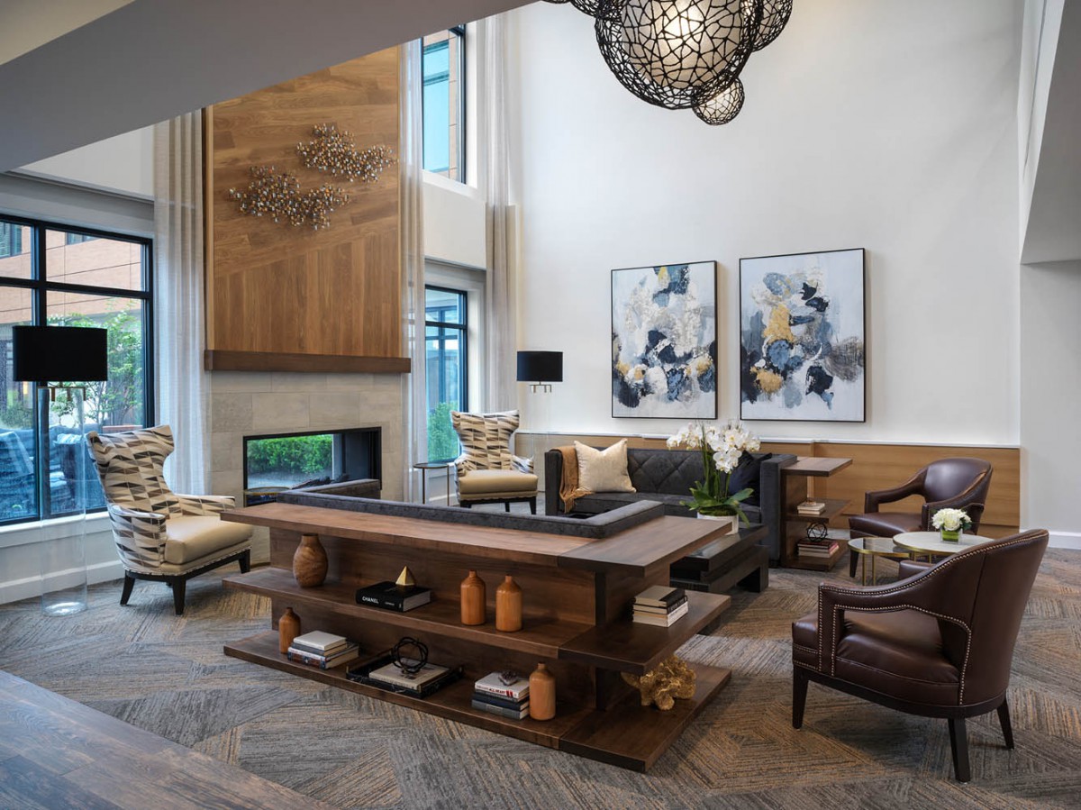 A modern living room with stylish furniture, a fireplace, and contemporary artwork.