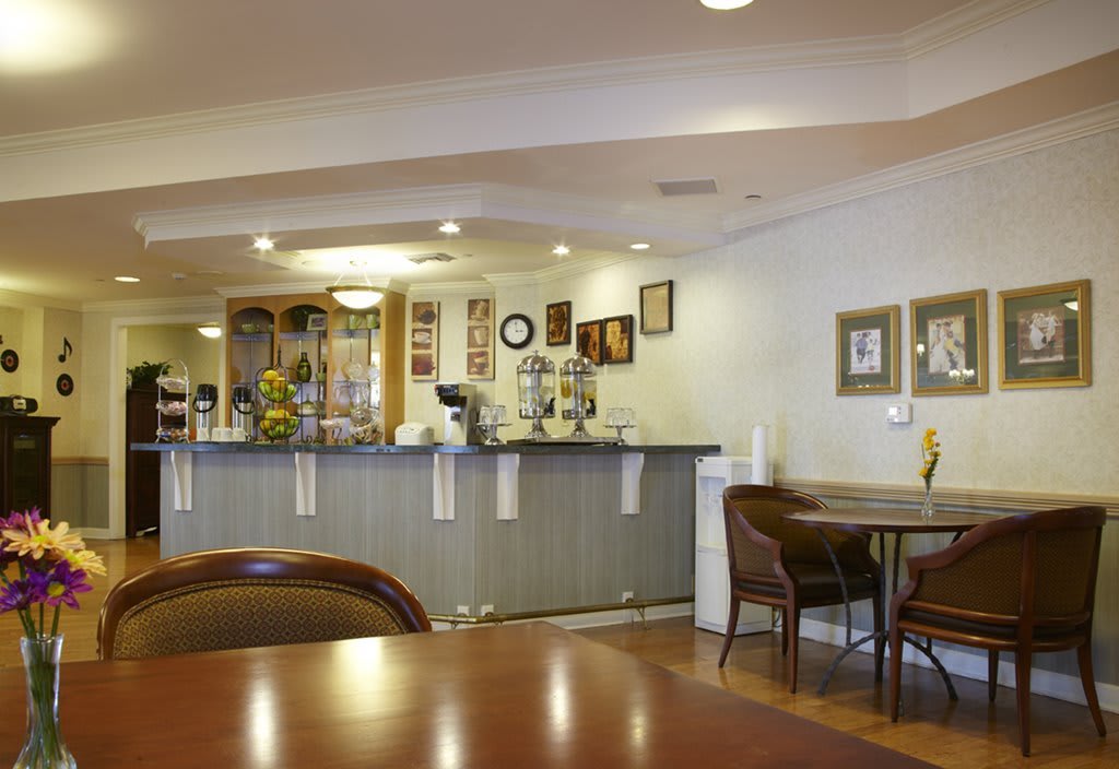 A cozy cafe interior with a seating area and counter.