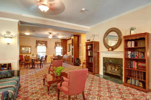 A cozy living room featuring elegant furniture, a fireplace, and classic decor.