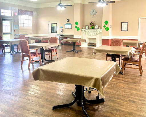 A spacious dining area with neatly arranged tables and chairs, ready for guests.