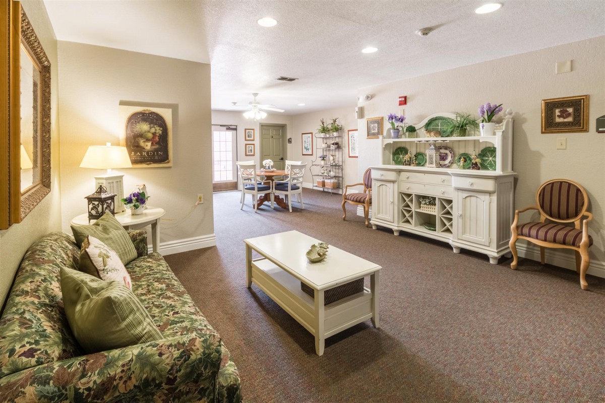 A cozy and traditionally styled living room with elegant furniture and warm lighting.