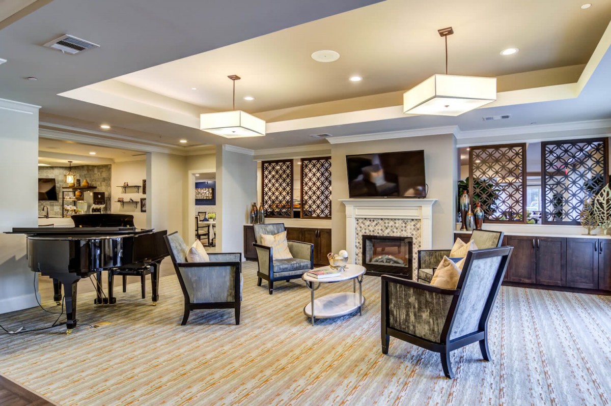 A modern living room with comfortable seating, a fireplace, and stylish lighting.